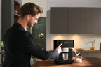 Miele CM6160 Freestanding Coffee Machine in Obsidian black — Miele CM6160 Freestanding Coffee Machine in Obsidian black — Miele CM6160 Freestanding Coffee Machine in Obsidian black — Miele CM6160 Beverage preparation in Obsidian black — In-situ shot